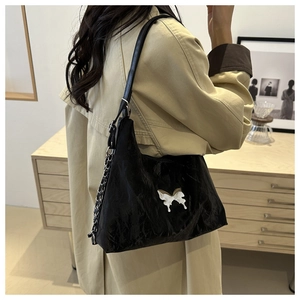 Black pleated shoulder bag with silver butterfly charm and metal chain strap for women