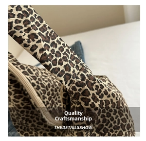 Detailed macro view of leopard print canvas bag seams and sturdy zipper connection