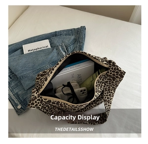 Internal capacity of leopard canvas tote bag showing books and everyday essentials