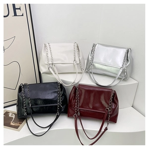 Detail showing high-shine crinkled leather chain tote bags in four trendy colors