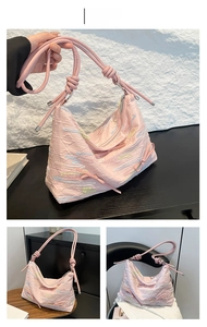 Detail of pink shoulder bag with bubble texture fabric and bow accent in a color display