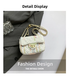Detail of white quilted crossbody bag with colorful embroidery and golden chain strap