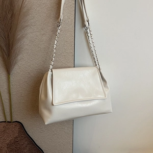 Chic beige crinkled leather tote bag with elegant silver chain shoulder strap