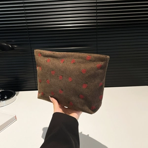 Brown corduroy makeup bag with red strawberry print and zipper closure for women