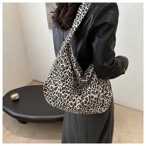 Close-up of a leopard print canvas hobo bag showing texture and trendy pattern design