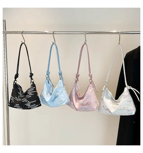Detail view of colorful textured tote bags with unique knotted rope shoulder straps
