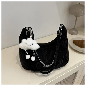 Detail of black crescent shoulder bag with silver chain and cute plush cloud charm