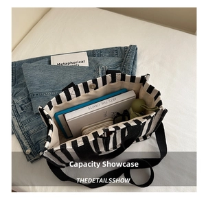Interior view showing the spacious capacity of this black and white striped canvas tote bag