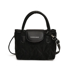 Minimalist black quilted bucket bag with white logo and removable shoulder strap