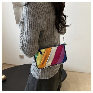 Rainbow striped crossbody bag with silver chain strap and metal rivet bottom detail
