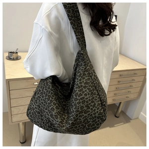 Leopard print canvas tote bag shown worn over the shoulder for high capacity and daily use