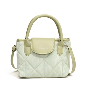 Minimalist light green quilted crossbody handbag with diamond stitching and top handle