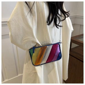 Detail of colorful striped crossbody bag with silver bead trim and chain strap