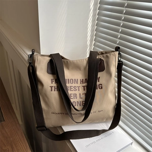 Chic khaki canvas tote bag with brown handles and adjustable crossbody strap for women
