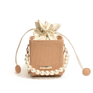Mini pearl handle bucket bag with khaki stripes and cream drawstring inner pouch