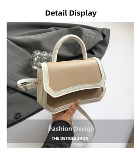 Close-up of fine stitching and cream contrast design on a modern crossbody bag