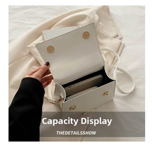 Internal capacity of white faux leather crossbody bag showing space for phone and small items