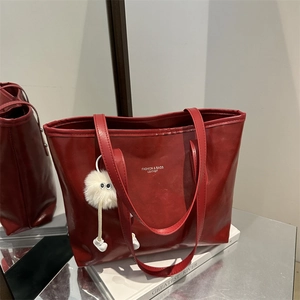 Glossy red large tote bag with fashion lettering and white plush ball pendant