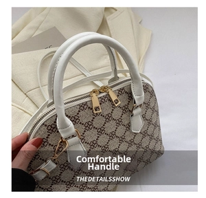 Detail of beige quilted shell bag featuring gold zippers and premium leather handles