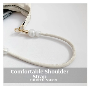 Detail of white leather shoulder strap with marble texture beads and gold hardware
