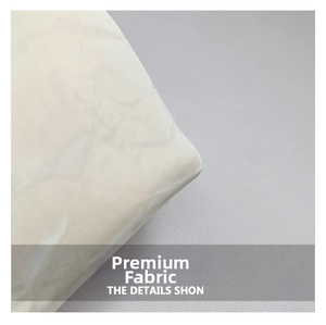 Detailed close-up of premium cream marble textured fabric showing durable corner stitching