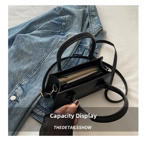 Internal structure of the black leather handbag showing compartments and storage capacity