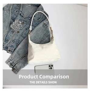 Detail of white baguette bag with large pearl beads and golden buckle on strap