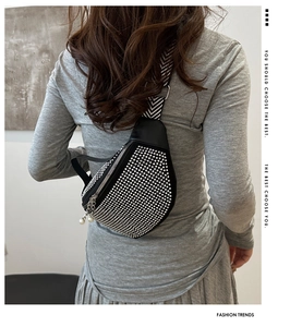 Fashionable black rhinestone chest bag with a geometric wide strap shown from a back view