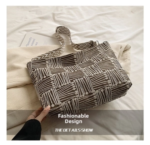Detailed view of brown and beige woven geometric pattern on a large canvas tote bag