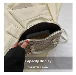 Interior view of vintage quilted shell bag showing space for smartphone and wallet