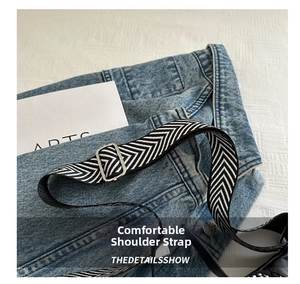 Detail of adjustable black and white chevron woven strap with silver metal buckle