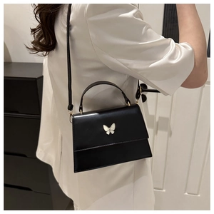 Elegant black faux leather crossbody bag for women with a white butterfly ornament