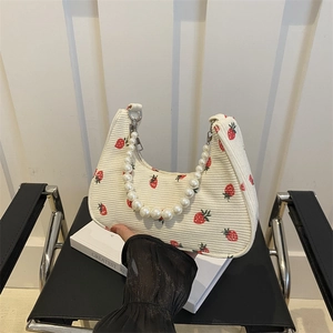 White corduroy strawberry hobo bag with pearl bead handle and floral print design