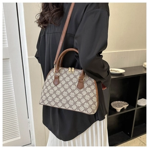 Retro diamond pattern shell handbag worn as a stylish shoulder bag over a black shirt