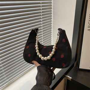 Black corduroy shoulder bag with strawberry prints and a white pearl chain handle