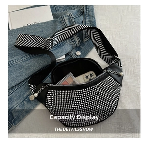 Detail view of rhinestone crescent bag interior showing phone and makeup storage capacity