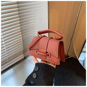 Close-up of the vintage orange lychee pattern leather handbag showing refined texture