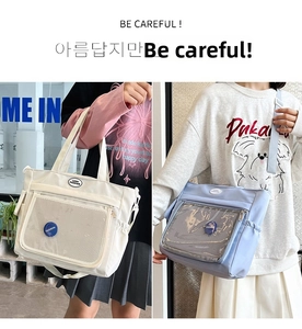 Detailed view of the large capacity tote bag with transparent mesh front pocket and straps