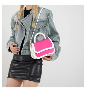 Detail of a french retro square bag in pink and white faux leather with adjustable strap