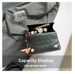 Detail view of stylish crossbody bag interior holding a smartphone and lipsticks