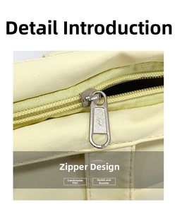 Close-up of smooth metal zipper closure on the large capacity yellow canvas tote bag