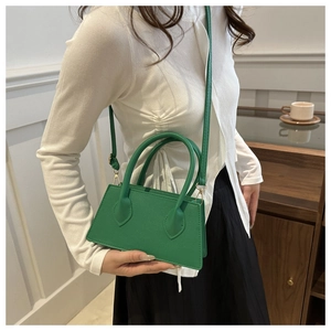 Detailed view of the green lychee pattern leather texture and craftsmanship on handbag