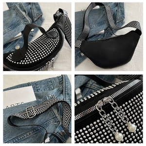 Detail view of rhinestone crescent waist bag with patterned strap and pearl chain