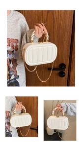 Detail of cream oval handbag with vertical quilting, woven handle and gold chain strap