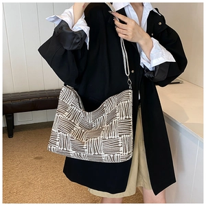 Detail of brown and white geometric knit pattern on a fashion crossbody shoulder bag