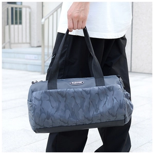 Detail of blue camouflage travel bag with fashion logo and side drawstring pocket