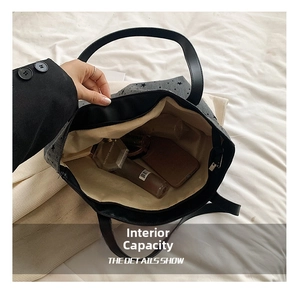 Spacious interior of dark gray star print tote bag showing organized daily essentials