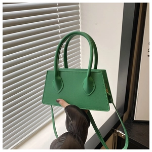 Detail of lime green mini trapezoid handbag with lychee grain texture and top handles