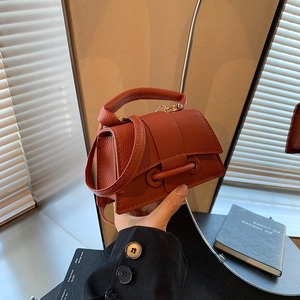 Rust red lychee grain leather handbag with circular ring flap and top handle for women