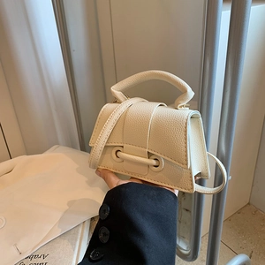 Minimalist beige litchi grain tote bag with curved base and crossbody strap